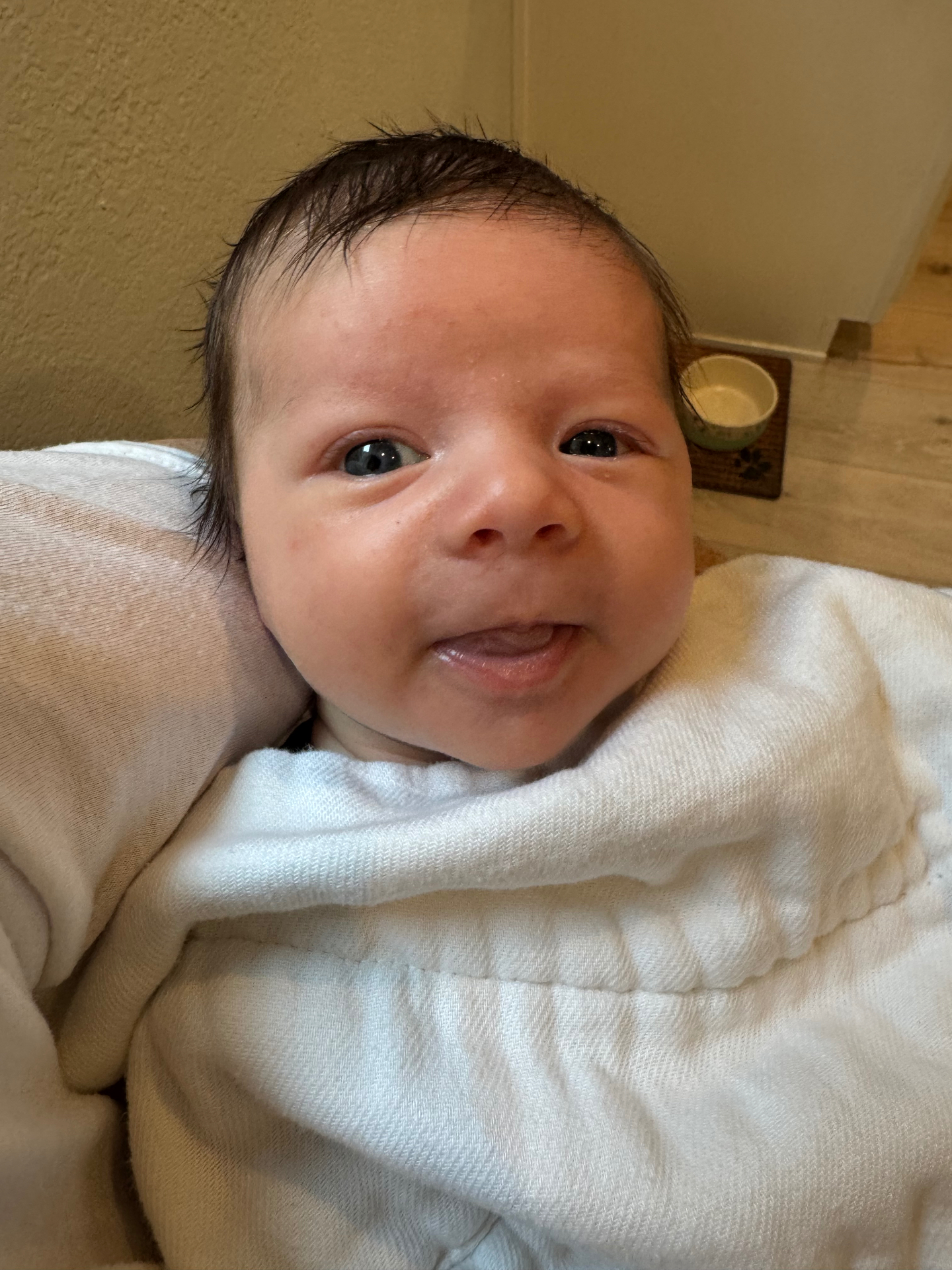 Ollie smiling, swaddled in white