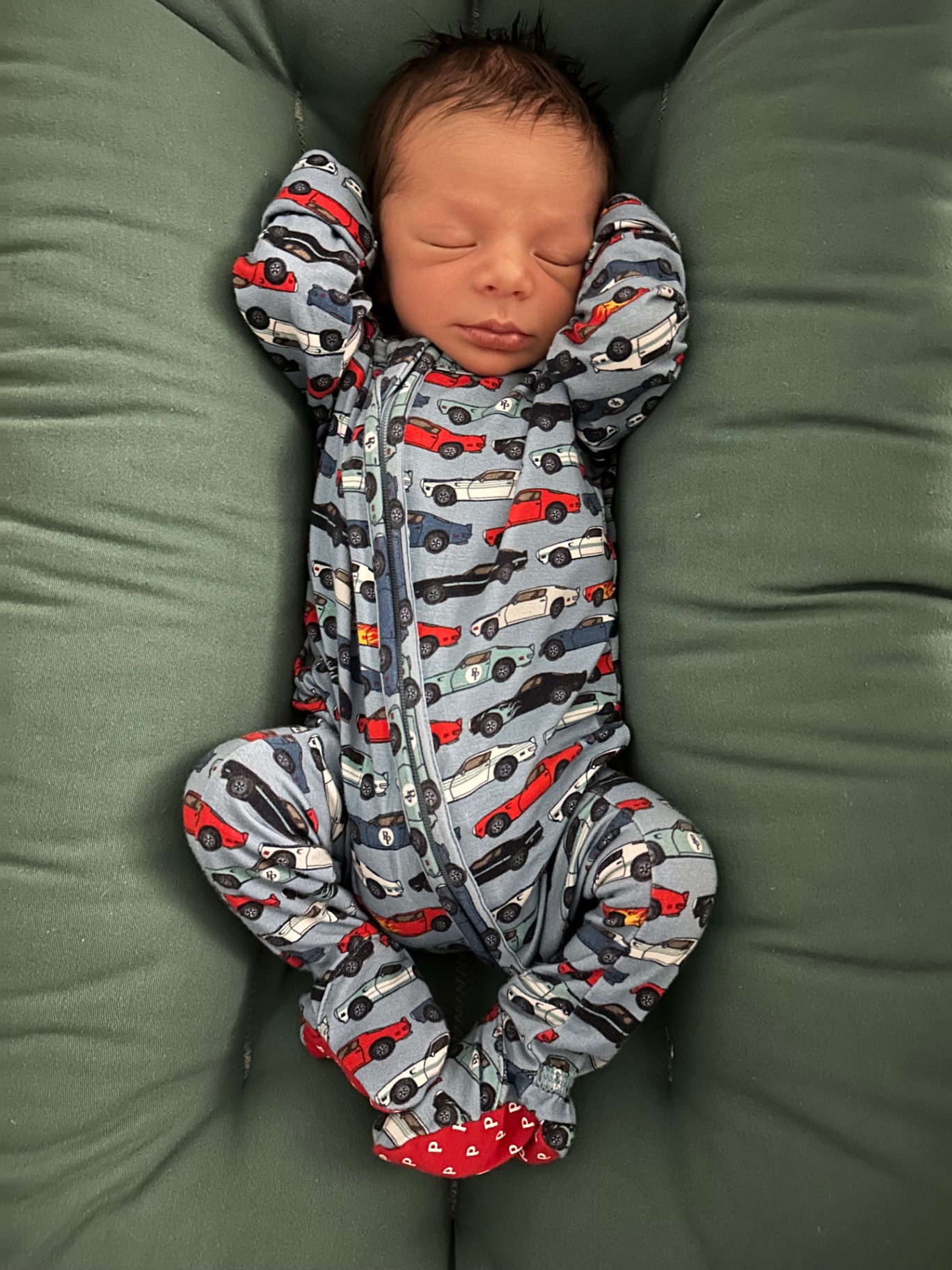 Ollie stretched out in car-print pajamas